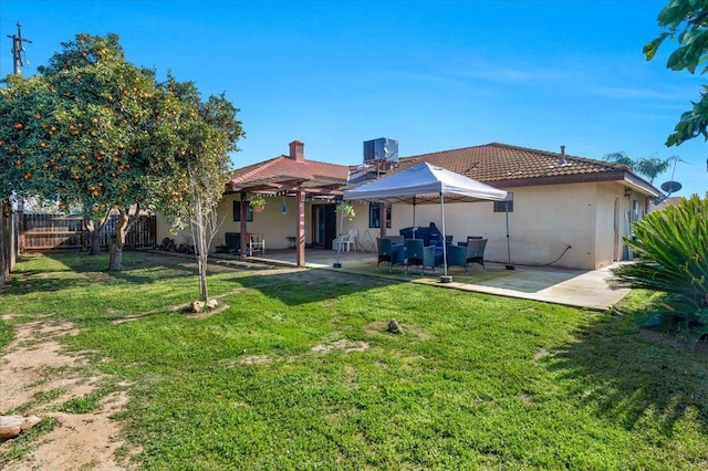 back of property featuring a patio, a pergola, and a lawn