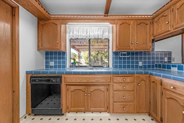 kitchen with sink, tasteful backsplash, and tile counters