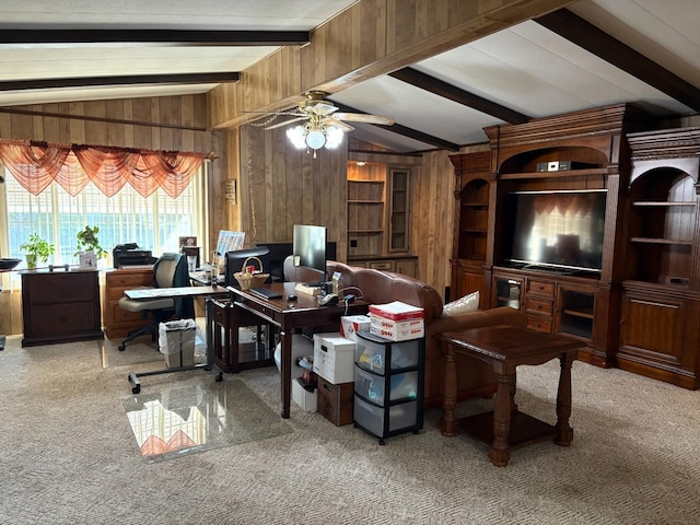 carpeted office space with ceiling fan, wooden walls, and lofted ceiling with beams