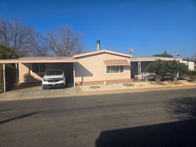 ranch-style house featuring a carport