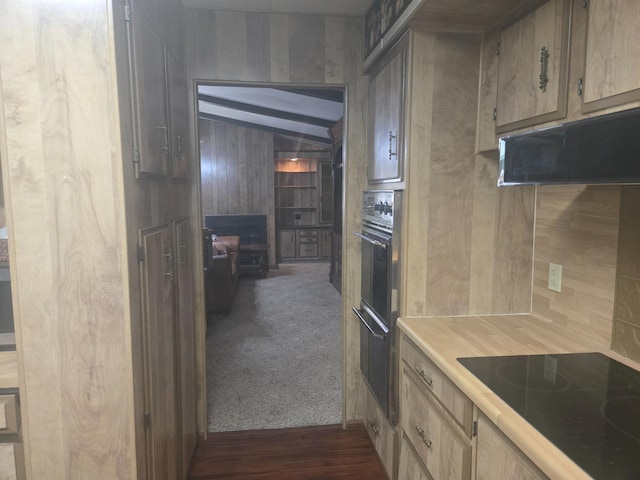 kitchen featuring black electric stovetop and dark colored carpet