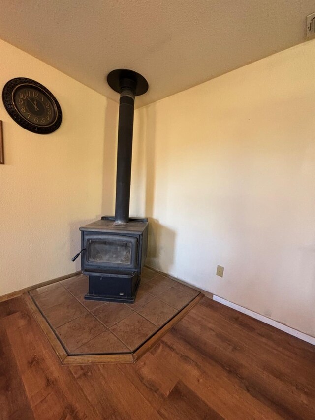 room details featuring wood finished floors and a wood stove