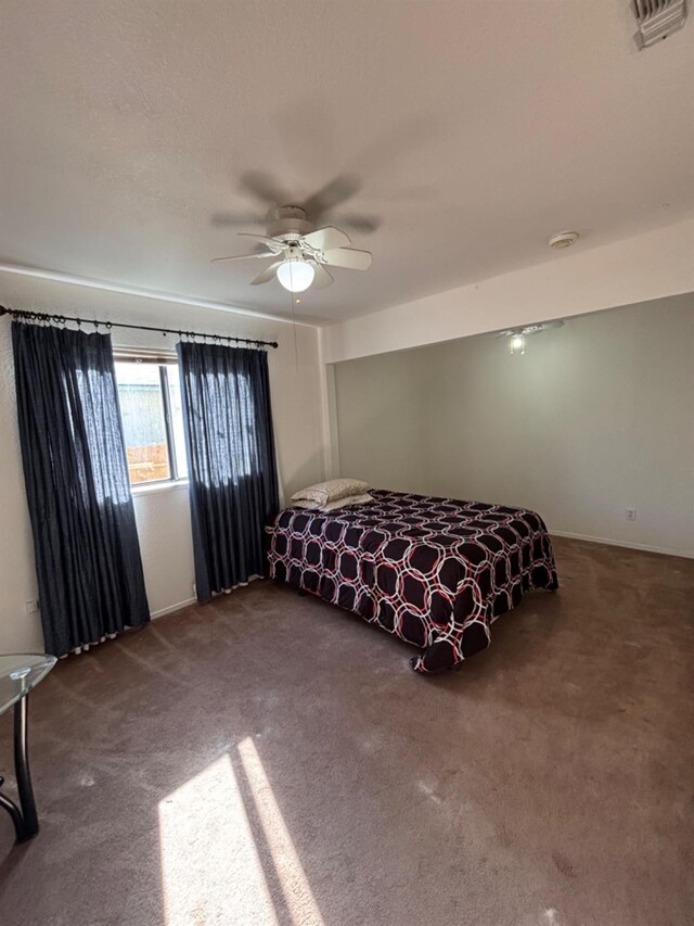 carpeted bedroom featuring visible vents and a ceiling fan