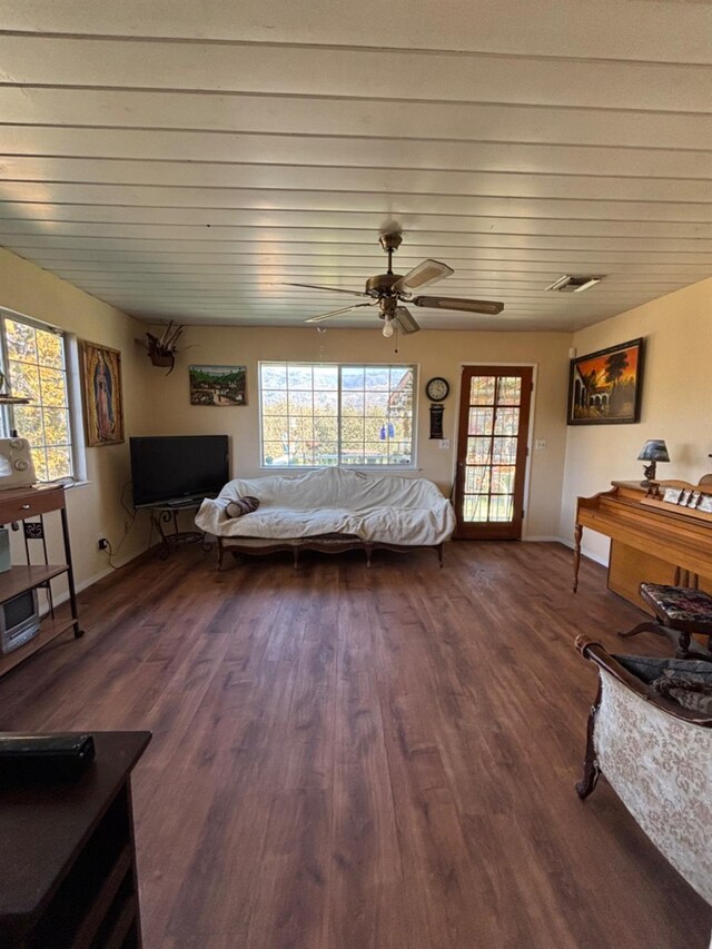 bedroom featuring dark wood-style floors, ceiling fan, multiple windows, and visible vents