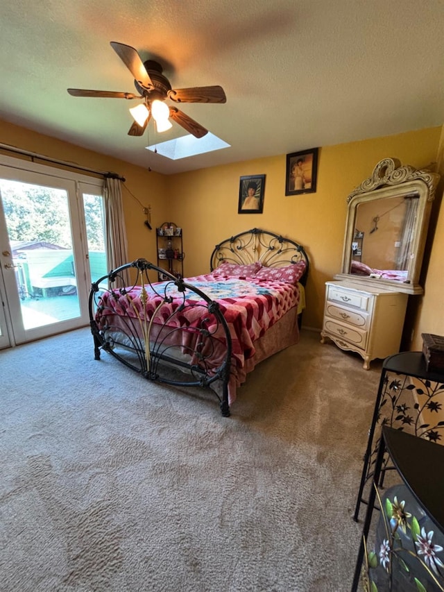 bedroom featuring ceiling fan, a textured ceiling, carpet, and access to outside