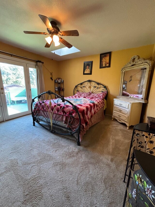 bedroom featuring carpet floors, access to outside, a ceiling fan, and a textured ceiling