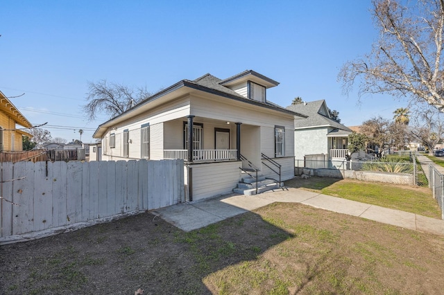 bungalow featuring a front lawn and covered porch