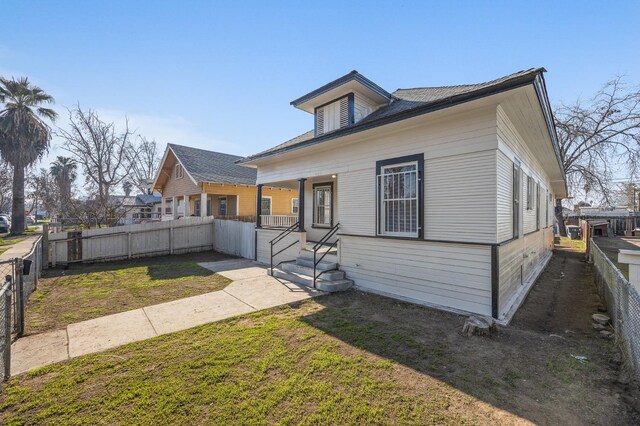 bungalow-style house with a front lawn and a porch