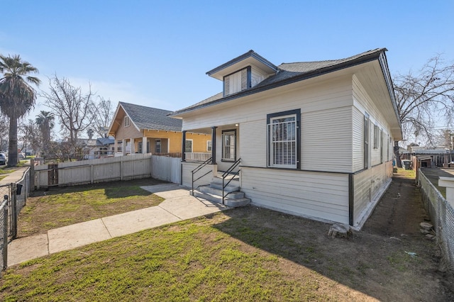 bungalow-style house featuring a front yard and covered porch