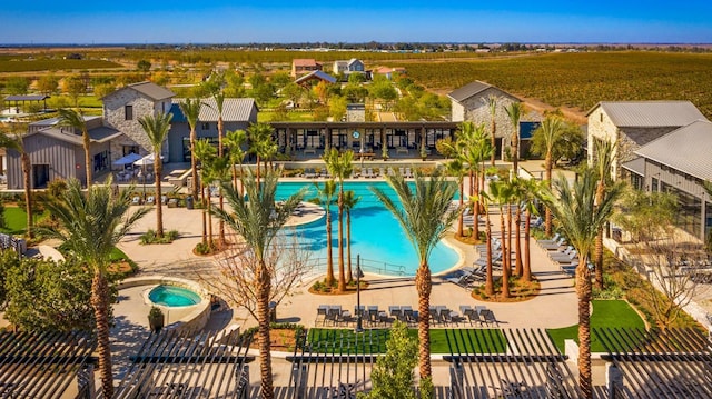 view of swimming pool featuring a patio area and a hot tub