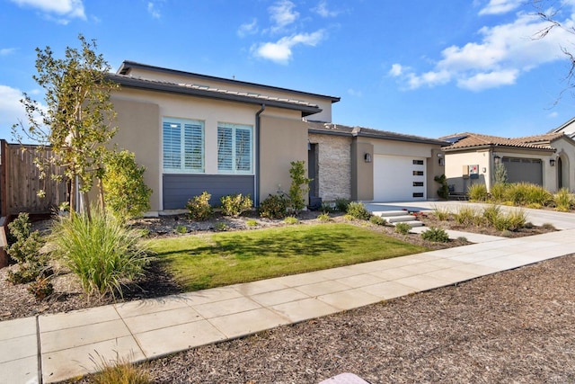 view of front of property featuring a front yard and a garage