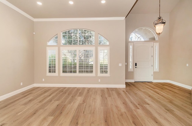 entryway with crown molding and light wood-type flooring