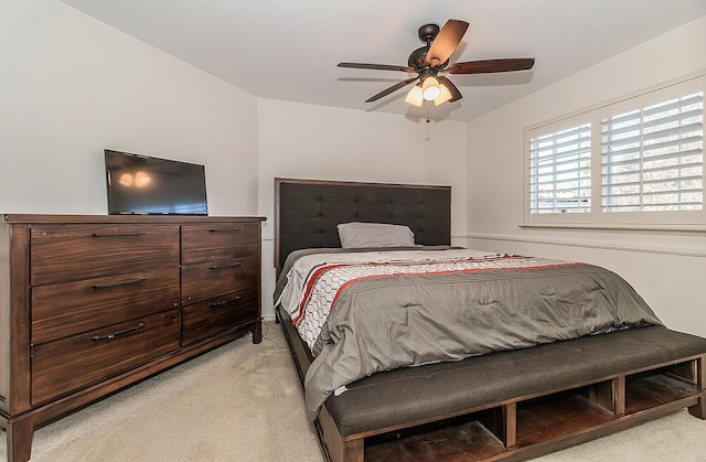 bedroom featuring light colored carpet and ceiling fan