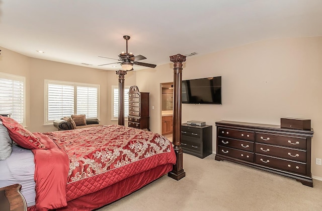 carpeted bedroom with ceiling fan and ensuite bath