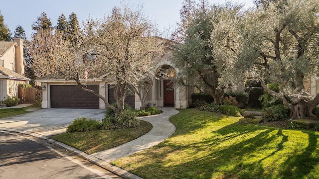 view of front of property with a garage and a front yard