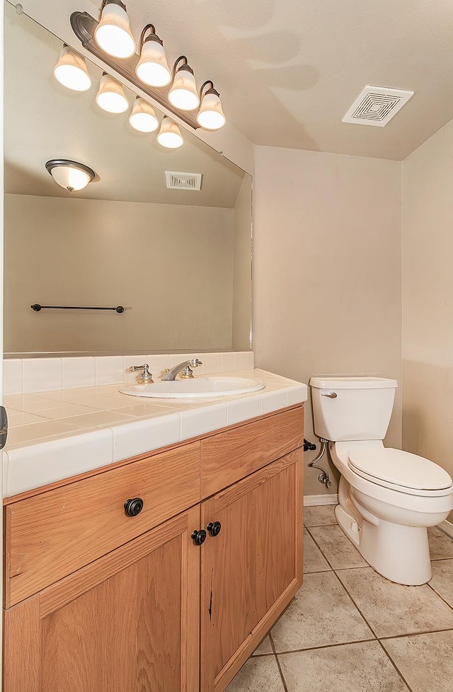 bathroom with vanity, tile patterned floors, and toilet