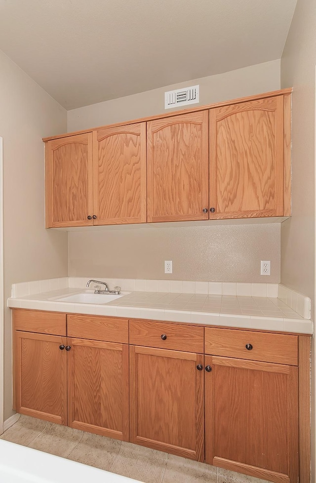 kitchen featuring sink and tile counters