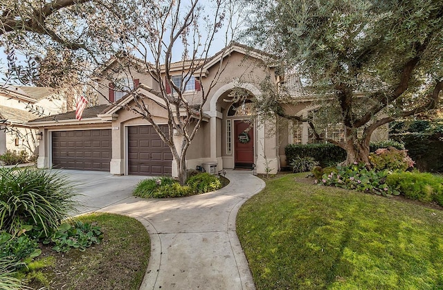 view of front of property featuring a garage and a front lawn