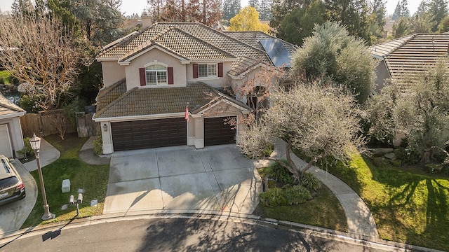 view of front of property with a garage and a front lawn