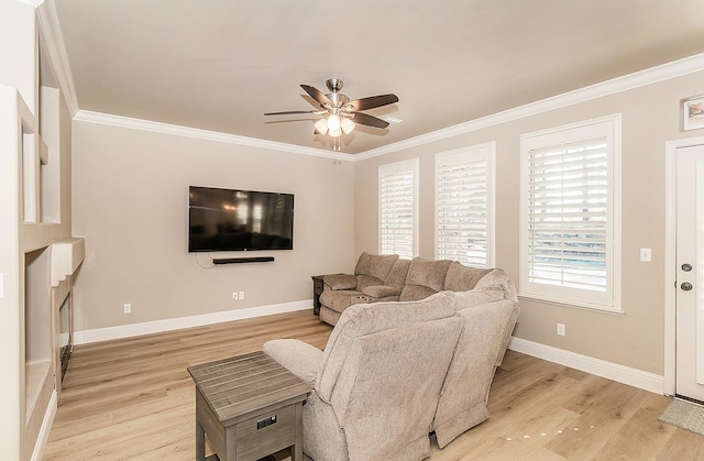 living room featuring crown molding, light hardwood / wood-style flooring, and ceiling fan