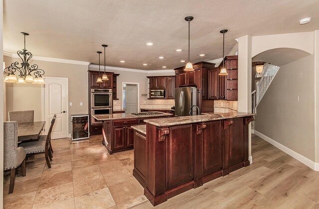 kitchen with tasteful backsplash, pendant lighting, stainless steel appliances, and kitchen peninsula