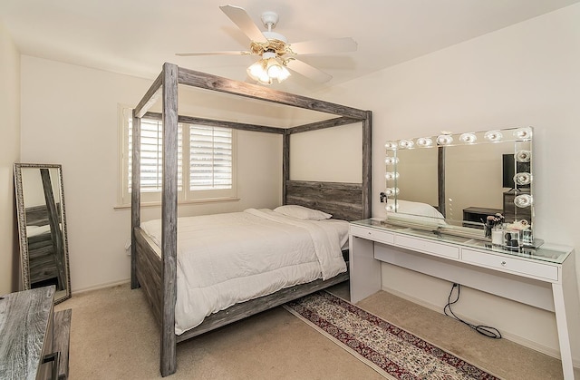 bedroom with ceiling fan and light carpet