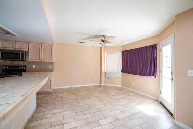 kitchen with light brown cabinetry, tasteful backsplash, electric range, ceiling fan, and tile countertops