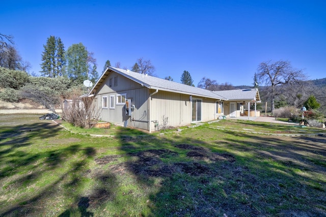 view of home's exterior with a patio area and a yard