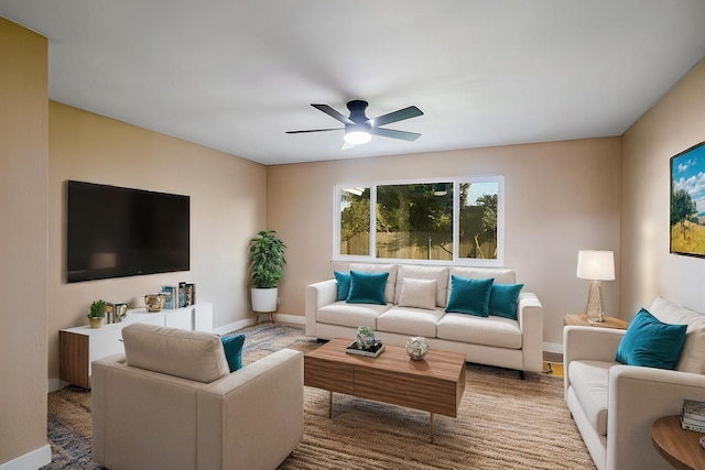 living room with baseboards and a ceiling fan