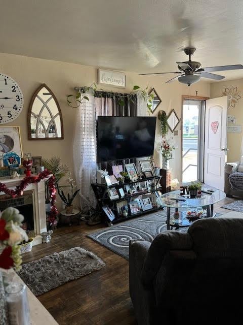 living room with ceiling fan and dark hardwood / wood-style floors