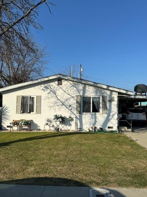 view of property exterior featuring a yard and a carport