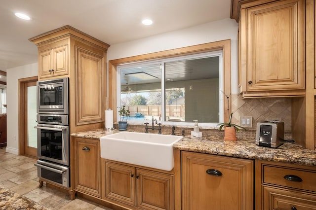 2519 24th Ave, Kingsburg, CA 93631 - kitchen with appliances with stainless steel finishes, a sink, tasteful backsplash, light stone counters, and stone tile floors