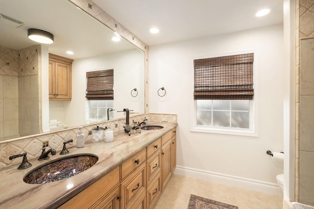 bathroom with tile patterned flooring, vanity, and toilet