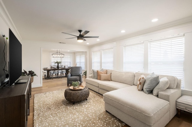 2519 24th Ave, Kingsburg, CA 93631 - living room with ornamental molding, light wood-style flooring, a ceiling fan, a chandelier, and recessed lighting
