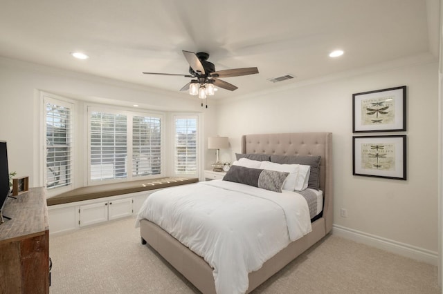 carpeted bedroom with ornamental molding and ceiling fan