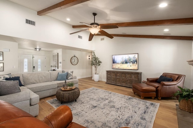 living room with vaulted ceiling with beams, ceiling fan, and light hardwood / wood-style flooring