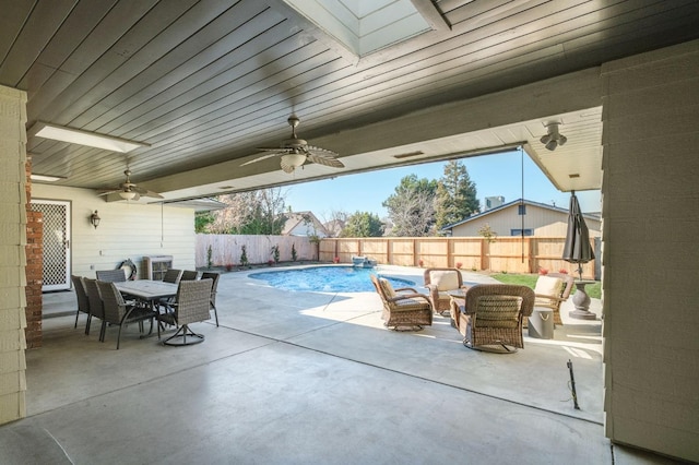 view of swimming pool with ceiling fan and a patio