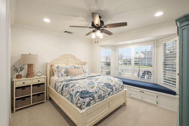 carpeted bedroom with ornamental molding and ceiling fan