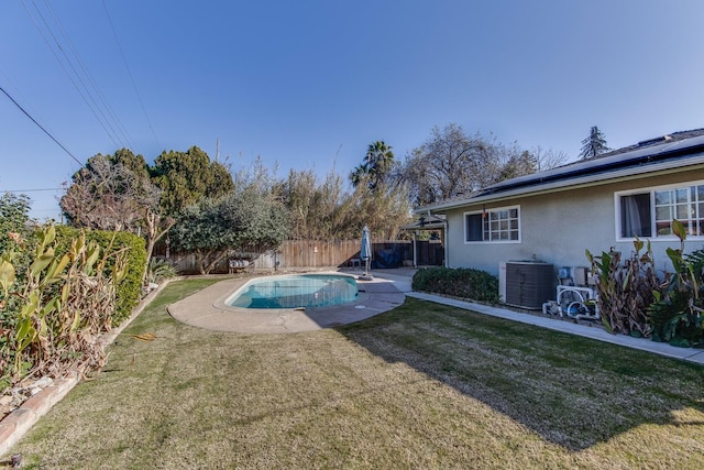 view of pool with a fenced in pool, a fenced backyard, a lawn, and central AC unit