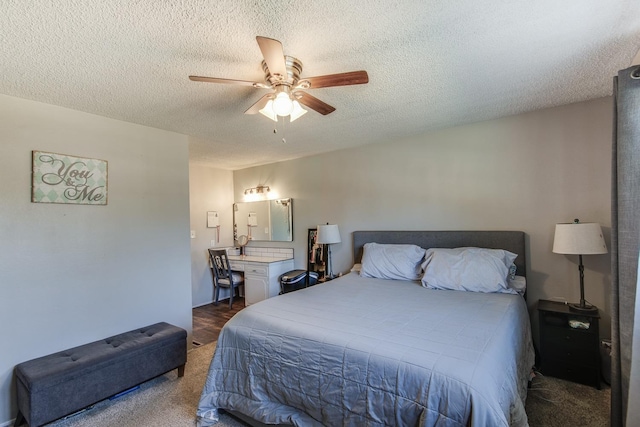 carpeted bedroom featuring ceiling fan and a textured ceiling