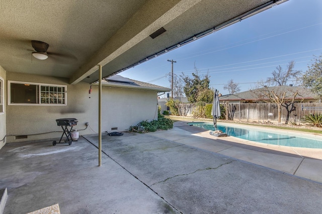 view of swimming pool featuring a fenced in pool, a patio area, ceiling fan, and a fenced backyard