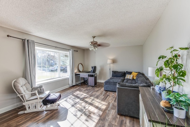 living area featuring ceiling fan, a textured ceiling, baseboards, and wood finished floors