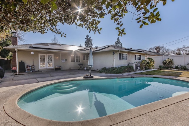 view of pool with a fenced in pool, fence, a patio, and french doors