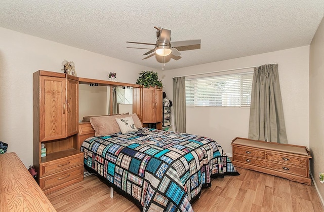 6779 N Woodson Ave, Fresno, CA 93711 - bedroom featuring light wood-style floors, a textured ceiling, and ceiling fan
