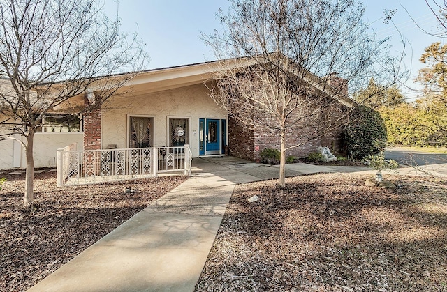 6779 N Woodson Ave, Fresno, CA 93711 - view of front of house featuring covered porch and stucco siding