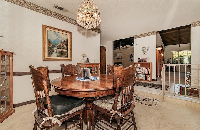 carpeted dining room with ceiling fan with notable chandelier and a textured ceiling