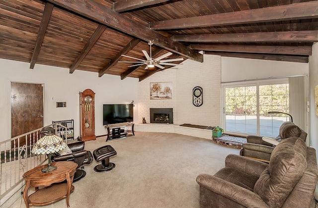 carpeted living room featuring a brick fireplace, wood ceiling, beamed ceiling, and ceiling fan