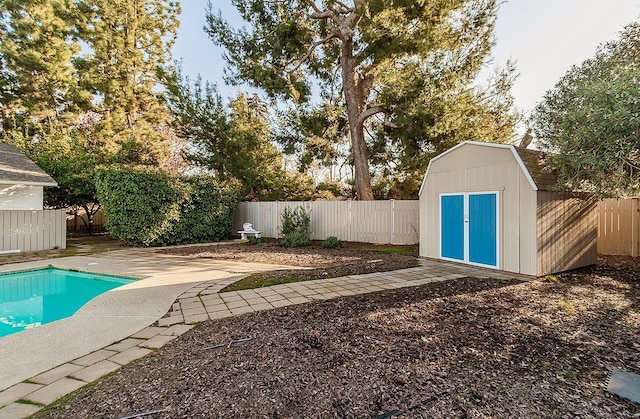 view of swimming pool featuring a storage unit and a patio area