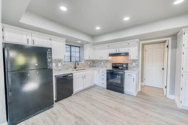 kitchen with white cabinetry, sink, light hardwood / wood-style flooring, and black appliances