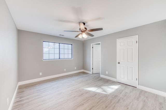 unfurnished bedroom with ceiling fan and light wood-type flooring